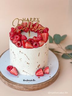 a birthday cake with strawberries on top