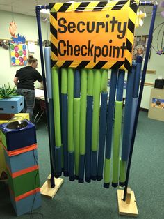 there is a sign that says security checkpoint in the middle of a group of crayons