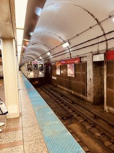 a subway station with people waiting for the train