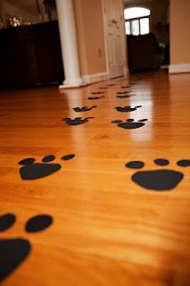 a wooden floor with black paw prints on it