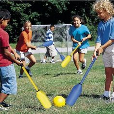 several children are playing with plastic bats and balls