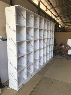 a large white bookcase sitting inside of a warehouse