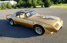 a gold colored car parked in a parking lot