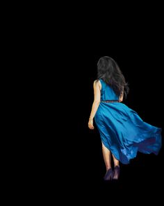 a woman in a blue dress is flying through the air