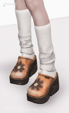 a woman's feet with white socks and brown clogs wearing flowered shoes