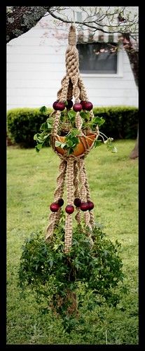 a hanging planter made out of rope and apples