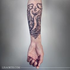 a man's arm with tattoos on it