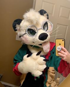 a person taking a selfie in front of a mirror with a cat costume on