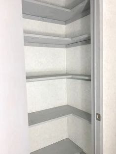 an empty white closet with shelves in it