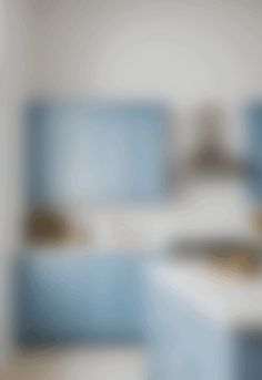 blurry image of a bathroom with blue bathtub and sink in the foreground