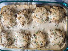 a casserole dish filled with meatballs covered in gravy and cheese