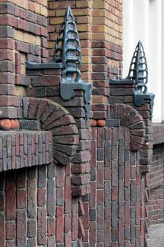 an old brick building with decorative iron work on it