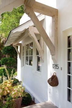 a white house with an awning over the front door