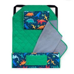 a green oven mitt with dinosaurs on it and a blue quilted pot holder