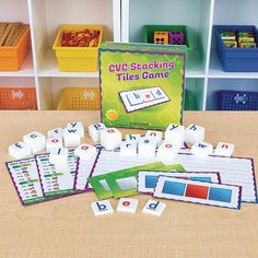 a table topped with lots of different types of letters and dices on top of it