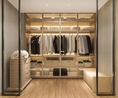 an empty walk in closet with clothes hanging on the walls and wooden flooring,