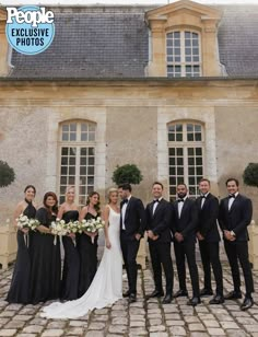 a group of people standing next to each other in front of a building