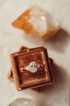 an engagement ring sitting in a velvet box