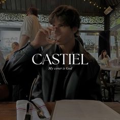 a man sitting at a table with a wine glass in his hand and the words castle above him