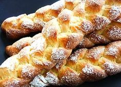 several croissants piled on top of each other with powdered sugar on them