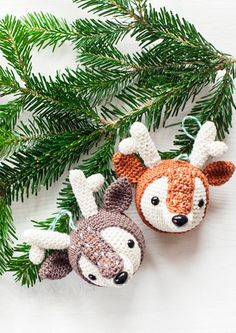 two crocheted animal ornaments hanging from a christmas tree