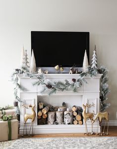 a living room decorated for christmas with deers and pine cones on the mantel