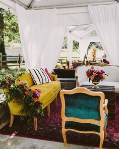 a living room filled with furniture and flowers