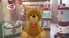 a large brown teddy bear standing in front of a store