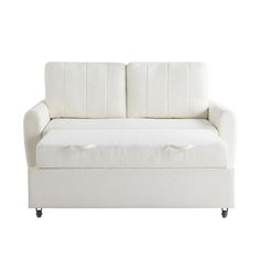 a white couch sitting on top of a wooden floor