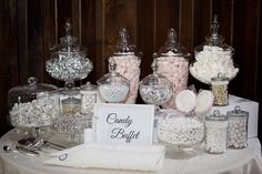 a table topped with lots of different types of candies and candy in glass jars