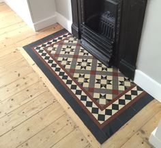 a room with a fireplace and rug on the floor