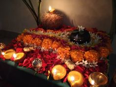 an arrangement of flowers and candles on a table