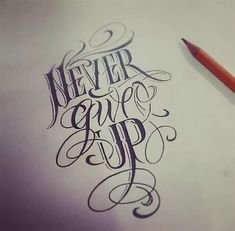 the words never give up written in cursive writing on a piece of paper