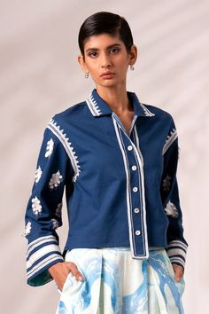 Indigo blue full sleeves collared top with cosmo bloom embroidery using tonal sequin embellishments. Paired with a white inverted pleated culottes with marble swerve print. - Aza Fashions Collared Tops With Embroidered Cuffs For Work, Fitted Floral Embroidery Top With Collared Neckline, Long Sleeve Tops With Embroidered Cuffs For Work, Fitted Long Sleeve Blouse With Embroidered Cuffs, Blue Long Sleeve Top With Resham Embroidery, Long Sleeve Tops With Embroidered Sleeves For Work, Chic Long Sleeve Tops With Embroidered Cuffs, Elegant Long Sleeve Tops With Geometric Embroidery, Bloom Embroidery