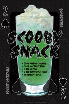 a green drink with white foam and sprinkles on the rim, in front of a black background