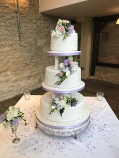 three tiered wedding cake with flowers on top