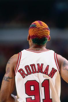 the back of a basketball player's jersey with multicolored hair