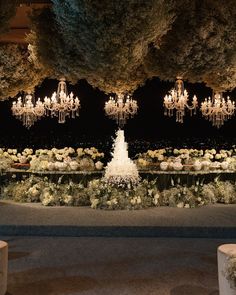 the chandeliers are hanging from the ceiling in front of an elaborate flower garden