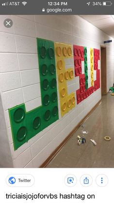 an image of a school hallway with legos on the wall and trash strewn around