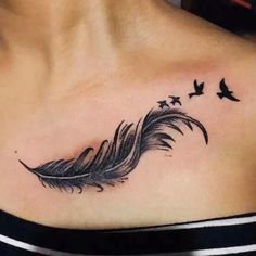 a woman's chest with a black feather and stars on the left side of her neck