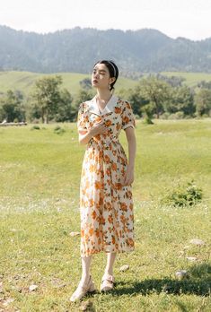 Emanate chic vintage vibes in this bold warm orange rose printed dress with short puff sleeves, notched collar, flower buttons and waist tie. S: 33" chest, 26.5" waist, 45" lengthM: 34.5" chest, 28" waist, 45" lengthL: 36" chest, 29.5" waist, 45" lengthXL: 37.5" chest, 31" waist, 45" length Vintage Peach Short Sleeve Dress, Peach Short Sleeve Daywear Dress, Peach Short Sleeve Dress For Daywear, Orange Short Sleeve Dress For Daywear, Sunset Rose, Midi Dress White, Rose Print Dress, Vintage Midi Dresses, 80s Dress