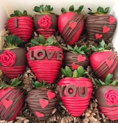 chocolate covered strawberries in a box with i love you written on the top one