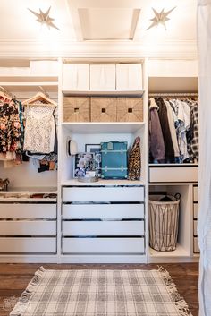 an organized closet with drawers and clothes hanging on the wall, along with other items