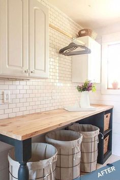 three buckets are sitting on the counter in this white and black laundry room area