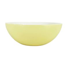 a yellow bowl sitting on top of a white table