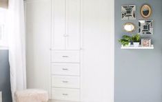 a bedroom with blue walls and white furniture