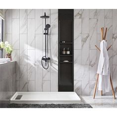 a white bath tub sitting under a window next to a wooden rack filled with towels