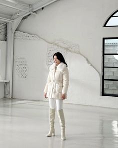 a woman is standing in an empty room