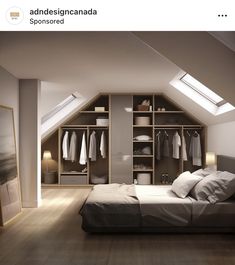 an attic bedroom with white walls and wooden flooring, built in shelving units