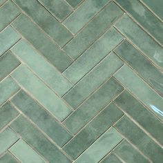 a close up view of a green tile floor